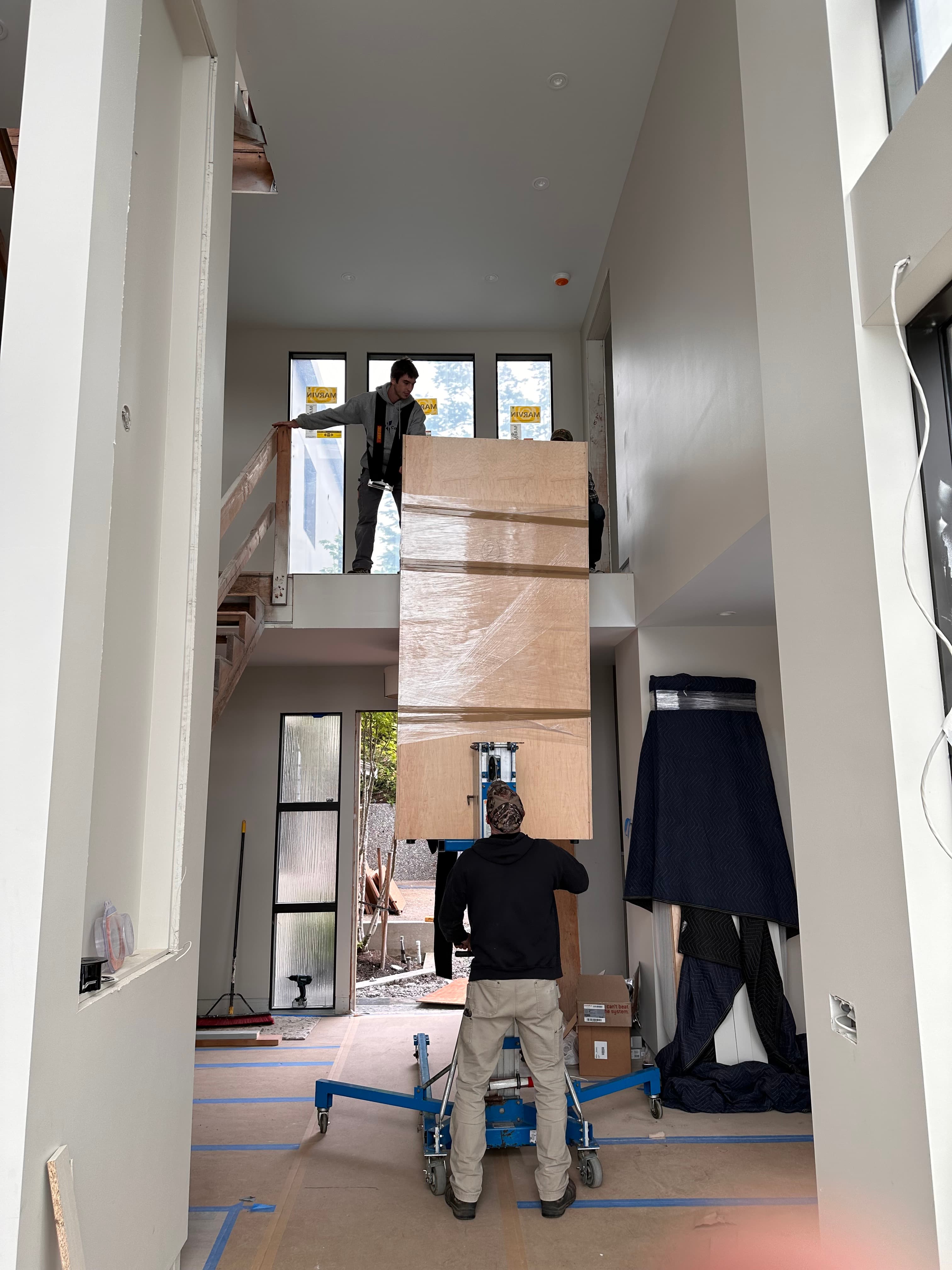 lifting a large door during construction